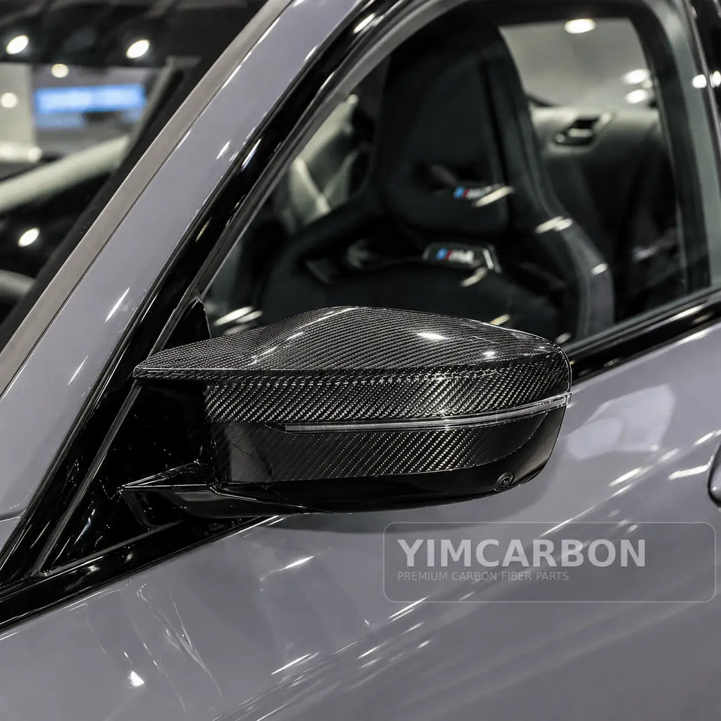 BMW M2 G87 dry carbon fiber mirror cap overlay installed on vehicle