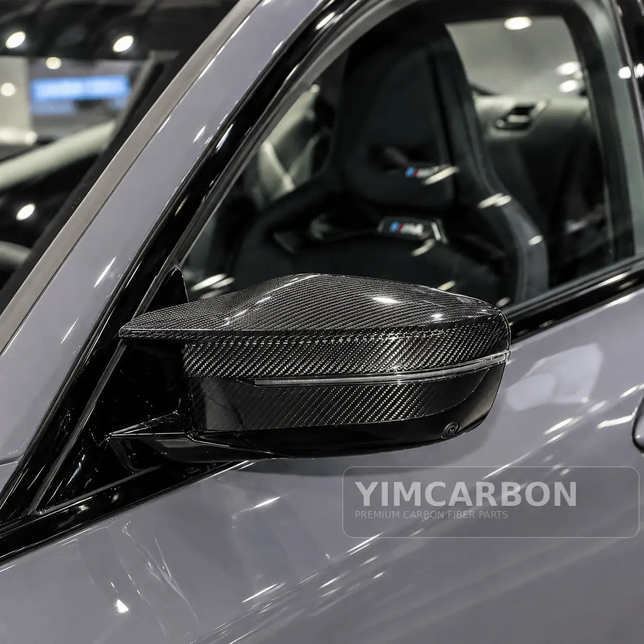BMW M2 G87 dry carbon fiber mirror cap overlay installed on vehicle