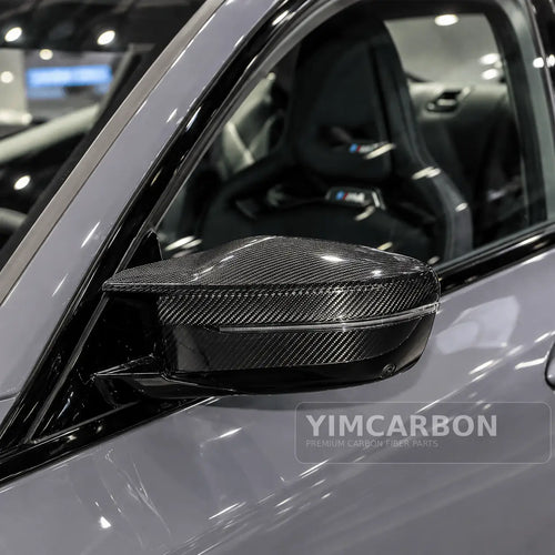 BMW M2 G87 dry carbon fiber mirror cap overlay installed on vehicle